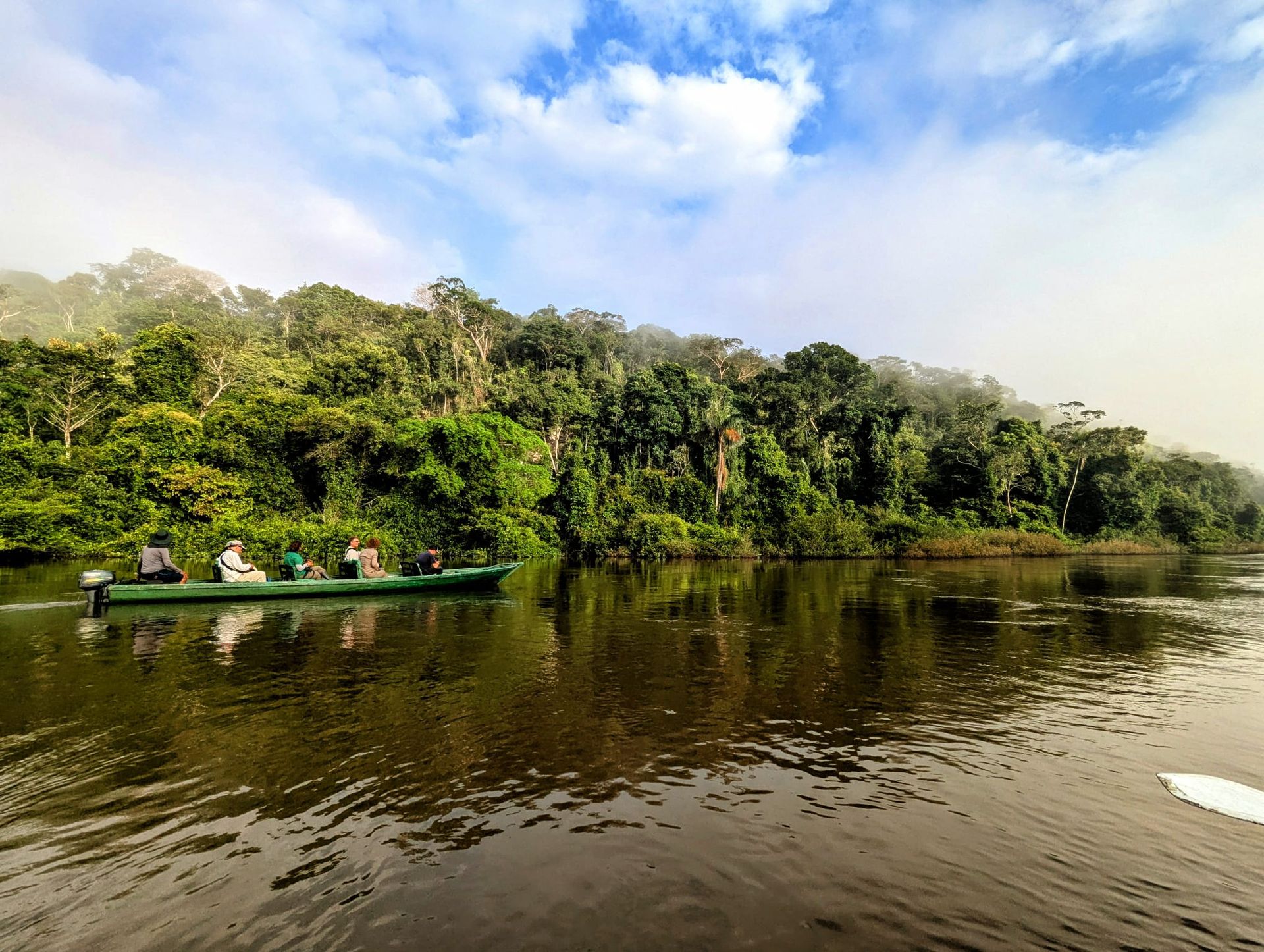 Naturalist canoe on the misty Rio Negro at dawn