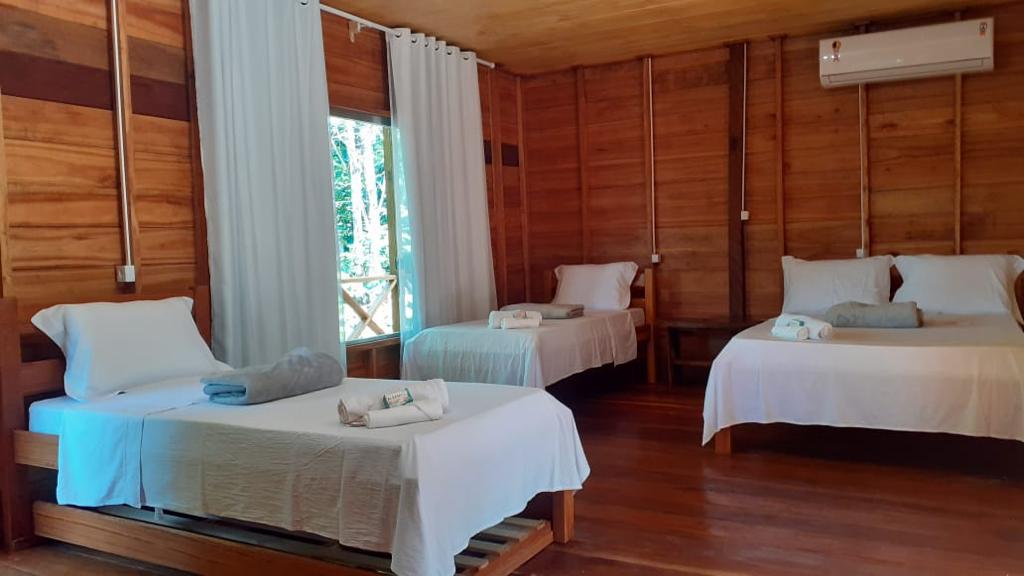 Modern en-suite lodge room with air conditioning overlooking the Amazon forest